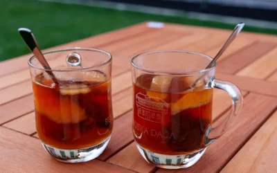 clear glass mug with brown liquid