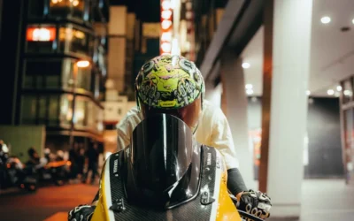 a man wearing a helmet sitting on a motorcycle