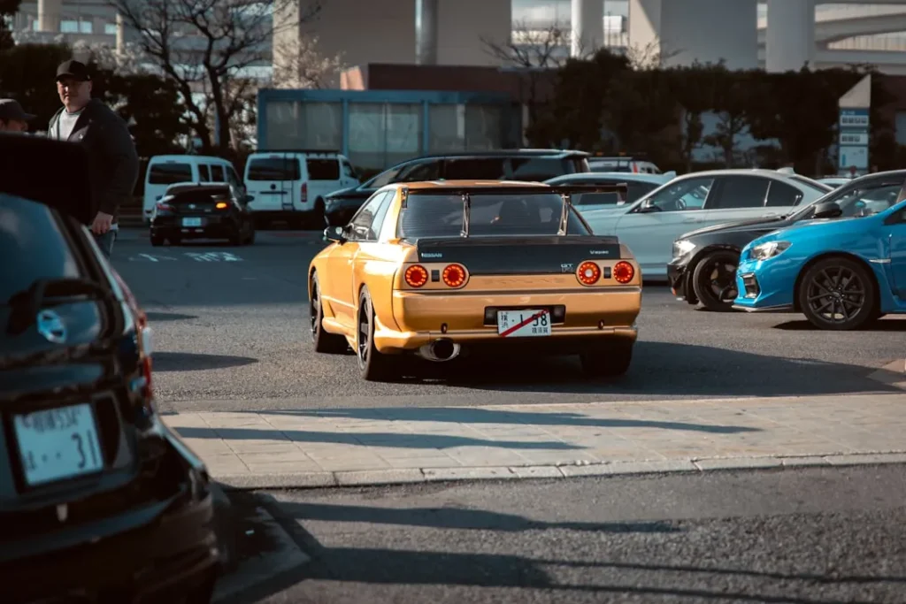 Yellow sports car with spoiler in parking lot