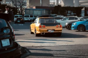 Yellow sports car with spoiler in parking lot