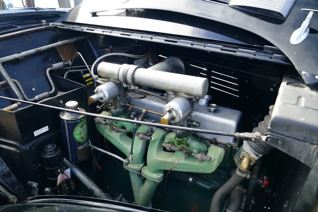 a car engine with green pipes