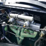 a car engine with green pipes