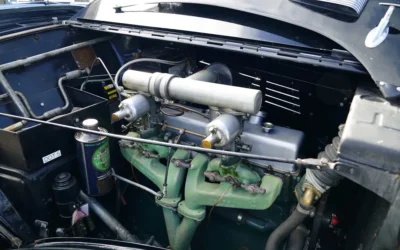 a car engine with green pipes
