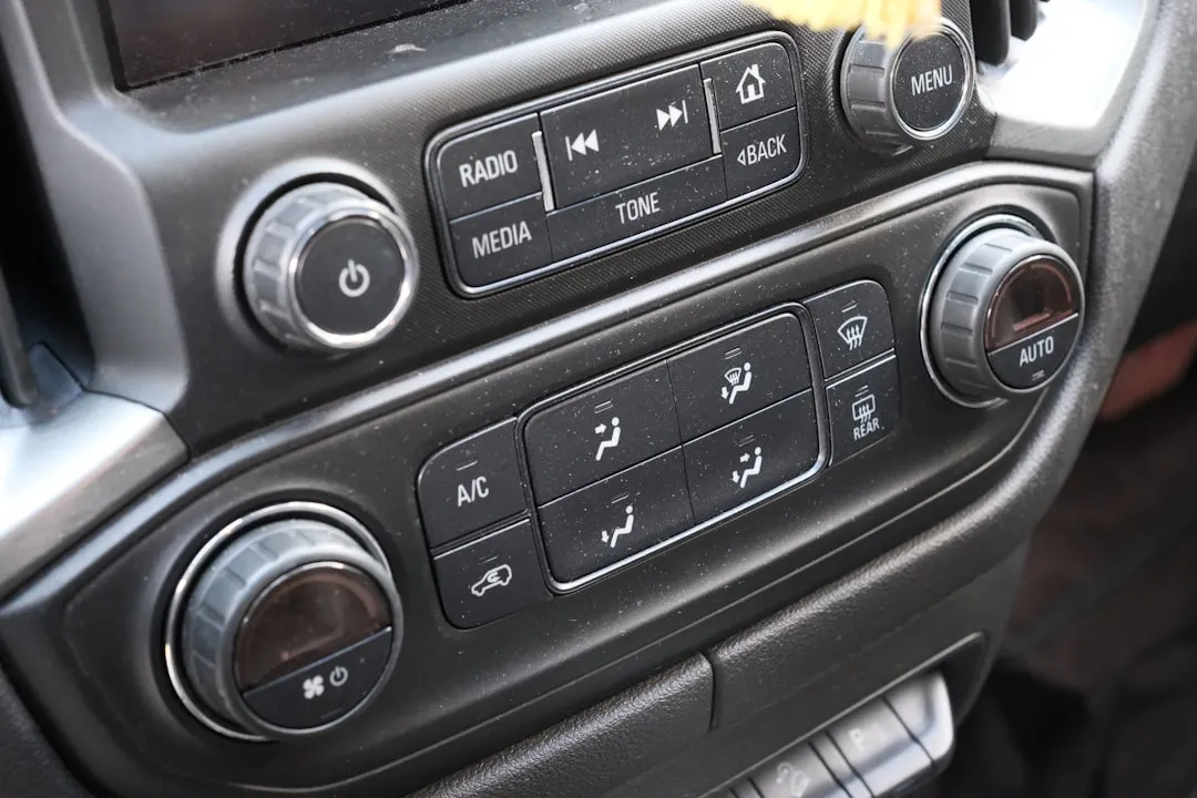 Car's dashboard showing controls for climate and media.