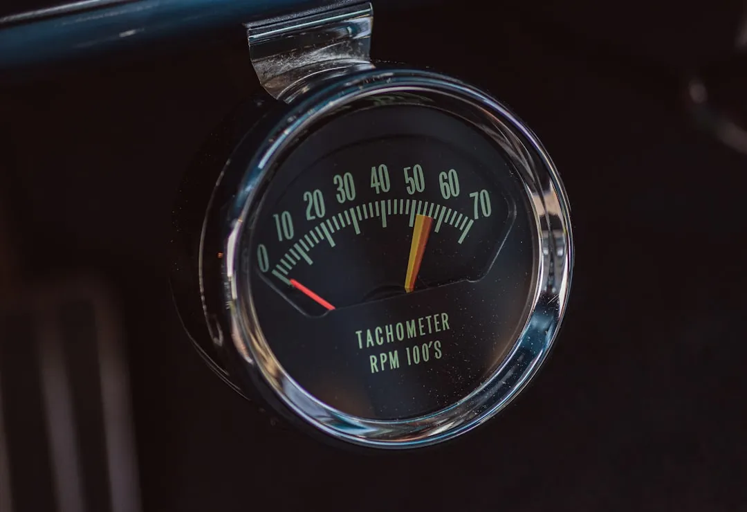 A car dashboard with a speedometer and gauge