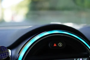 a close up of a car dashboard with a blue light