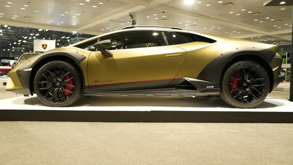 a yellow sports car on display in a showroom