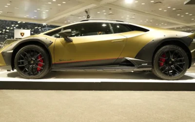 a yellow sports car on display in a showroom