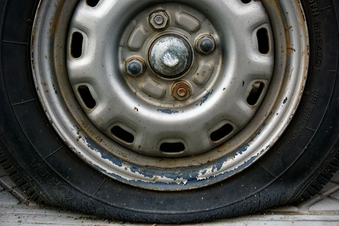 Close-up of a worn car tire and rim.