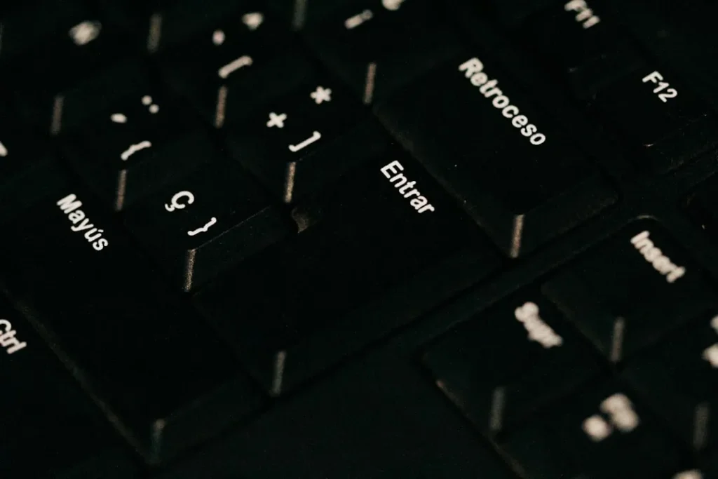 a close up of a black keyboard with white letters