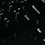 a close up of a black keyboard with white letters