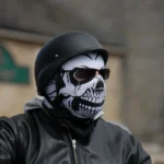 a man wearing a skeleton mask and black leather jacket