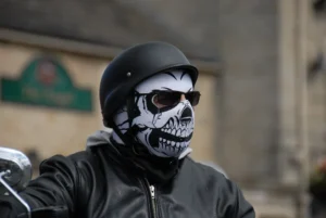 a man wearing a skeleton mask and black leather jacket