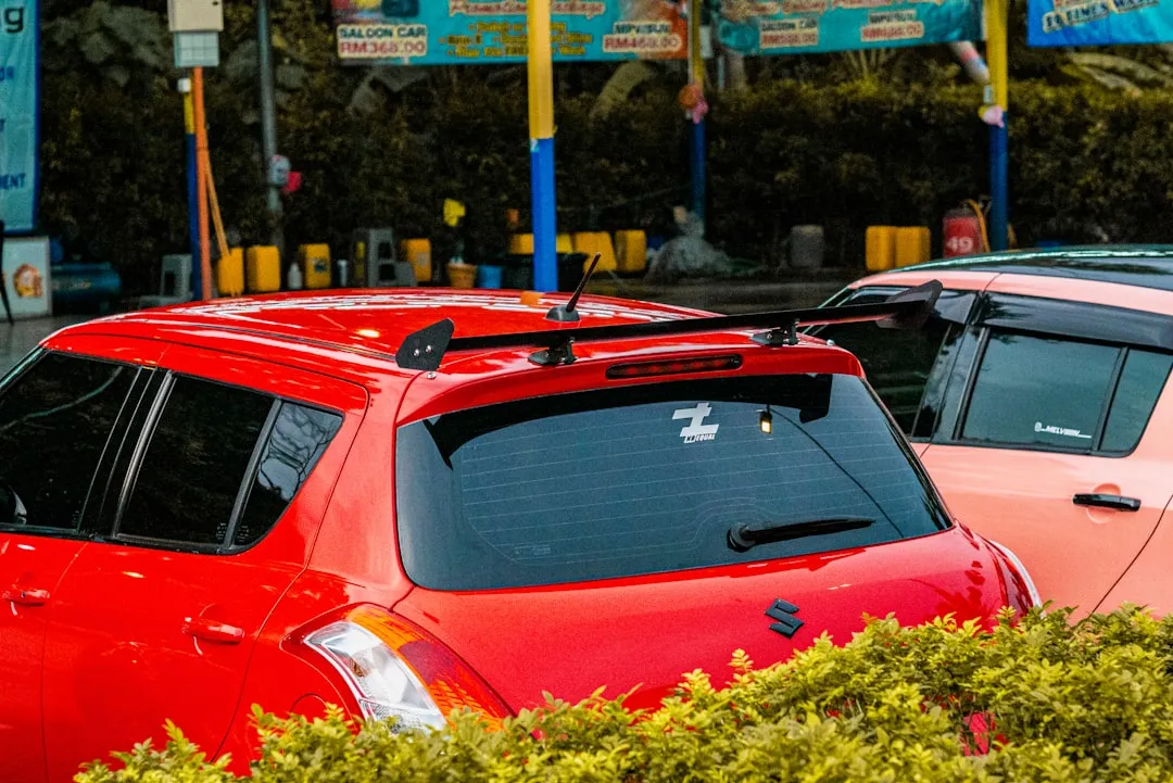 a couple of red cars parked next to each other