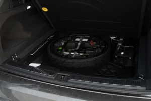 Spare tire and tools in car trunk
